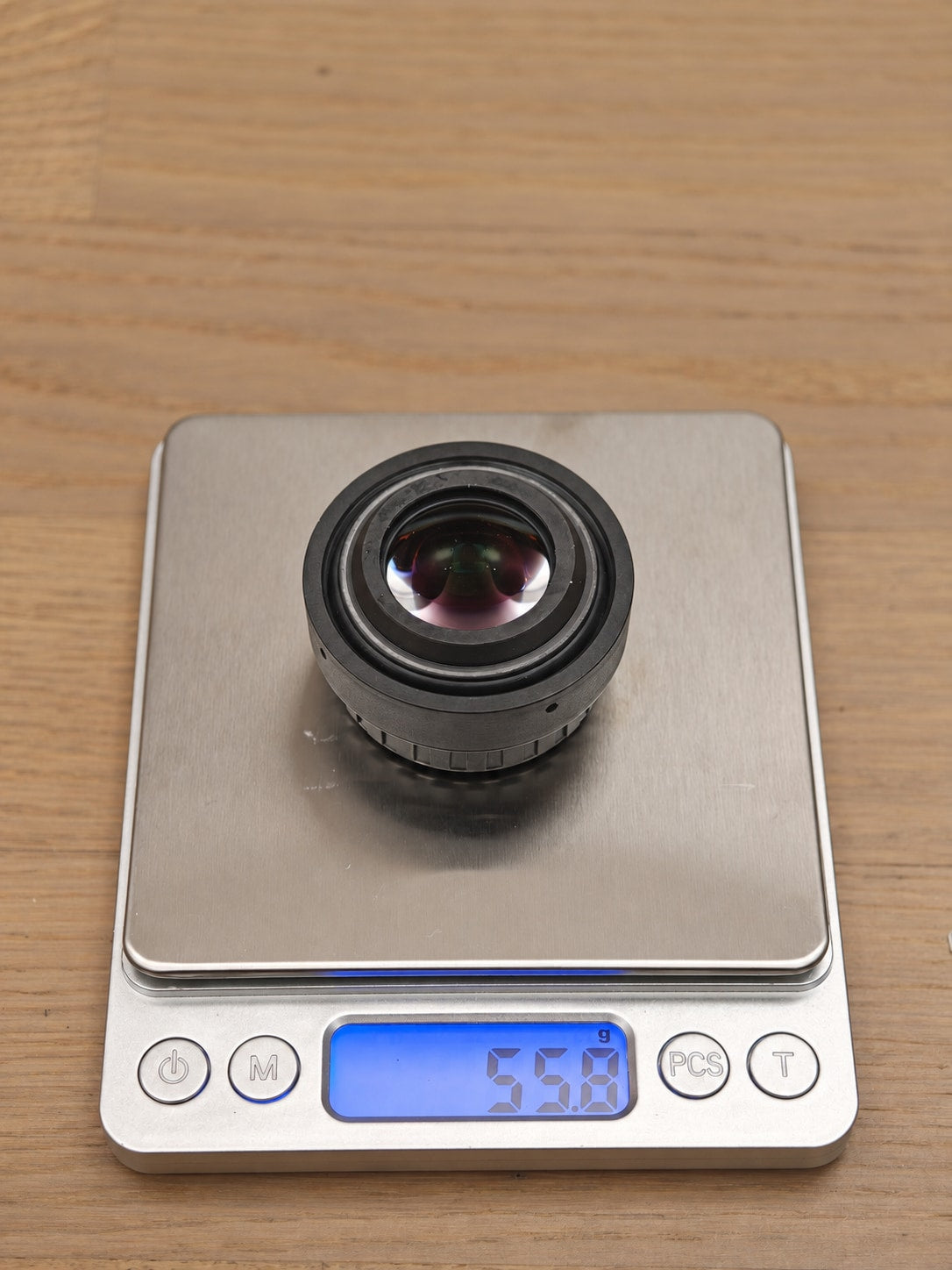 Norinco LW40 eyepiece sample on scale displaying 55.8 g