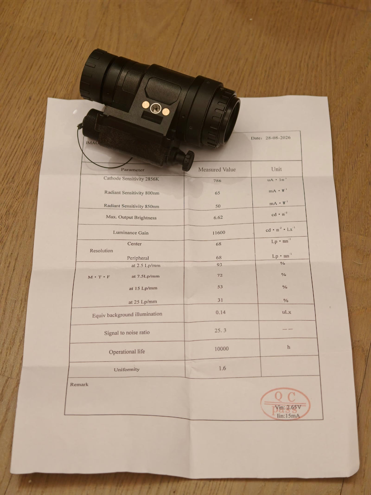 Tube data sheet photographed from one actual PVS-14 unit; its measured values apply to that unit only, while every supplied tube is at least FOM 1600.