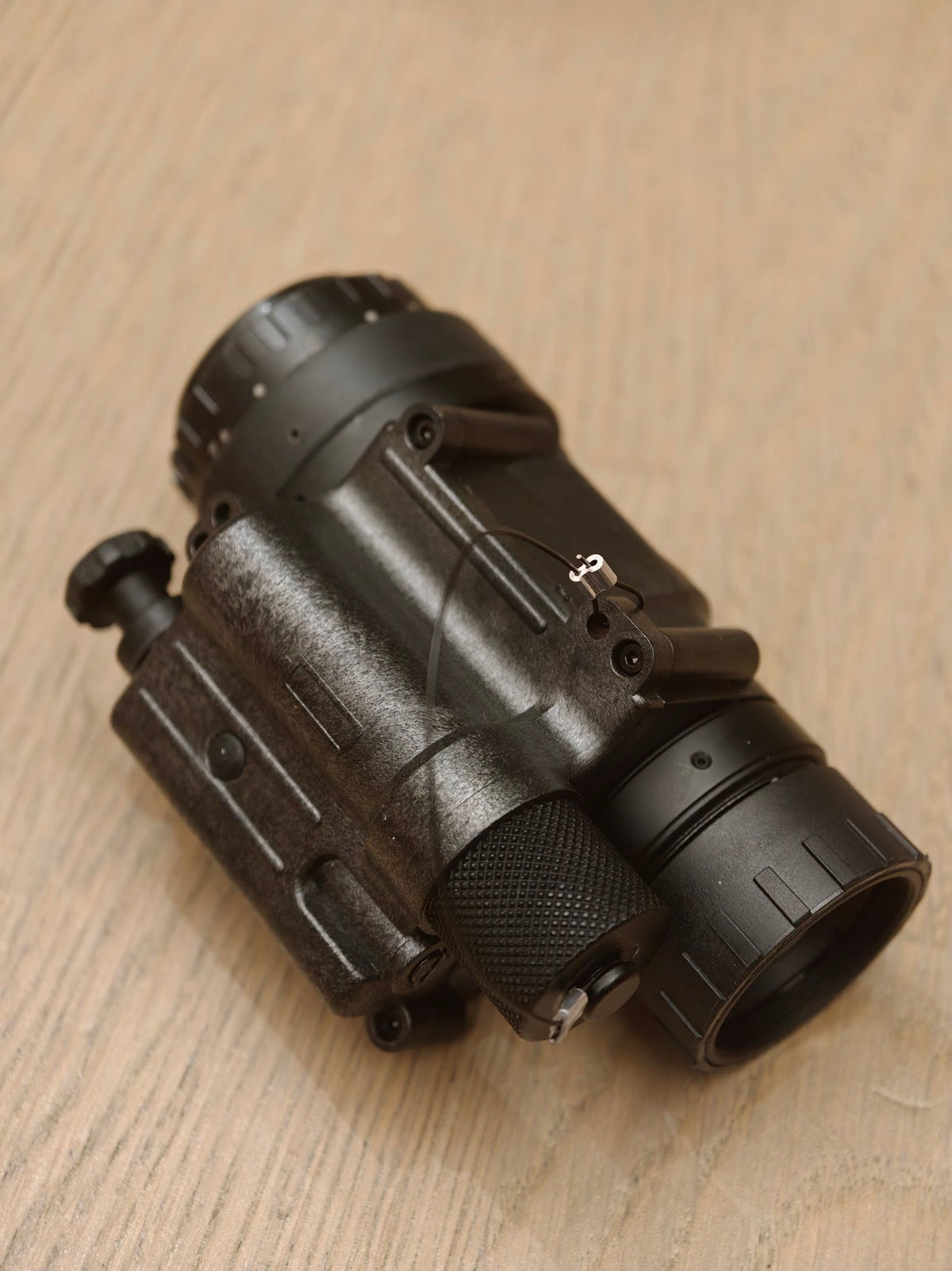 Reference side view of the PVS-14 monocular; its housing gain control is inactive with the supplied auto-gain tube.