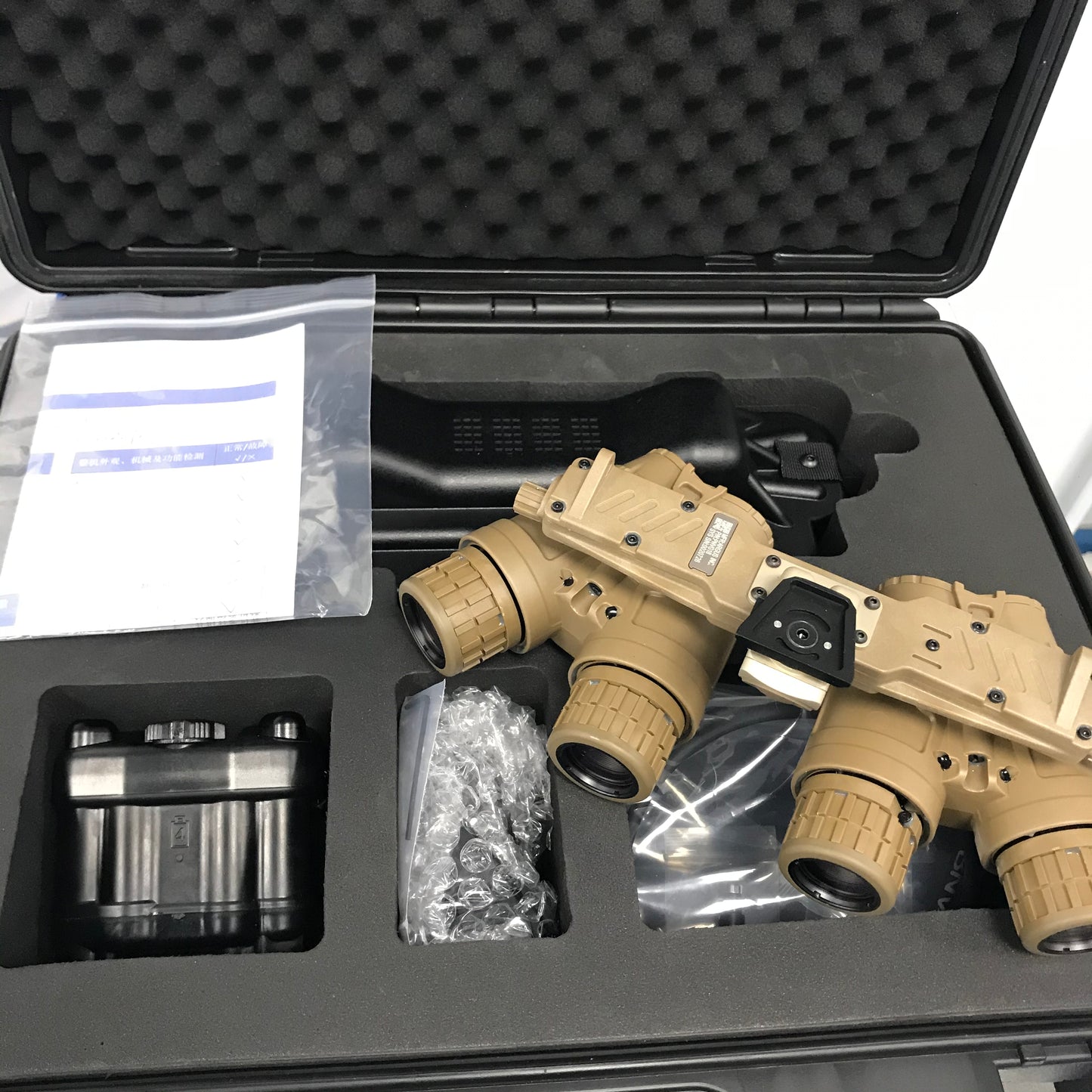 Tan ARGUS APNVG device with accessories in a fitted protective case