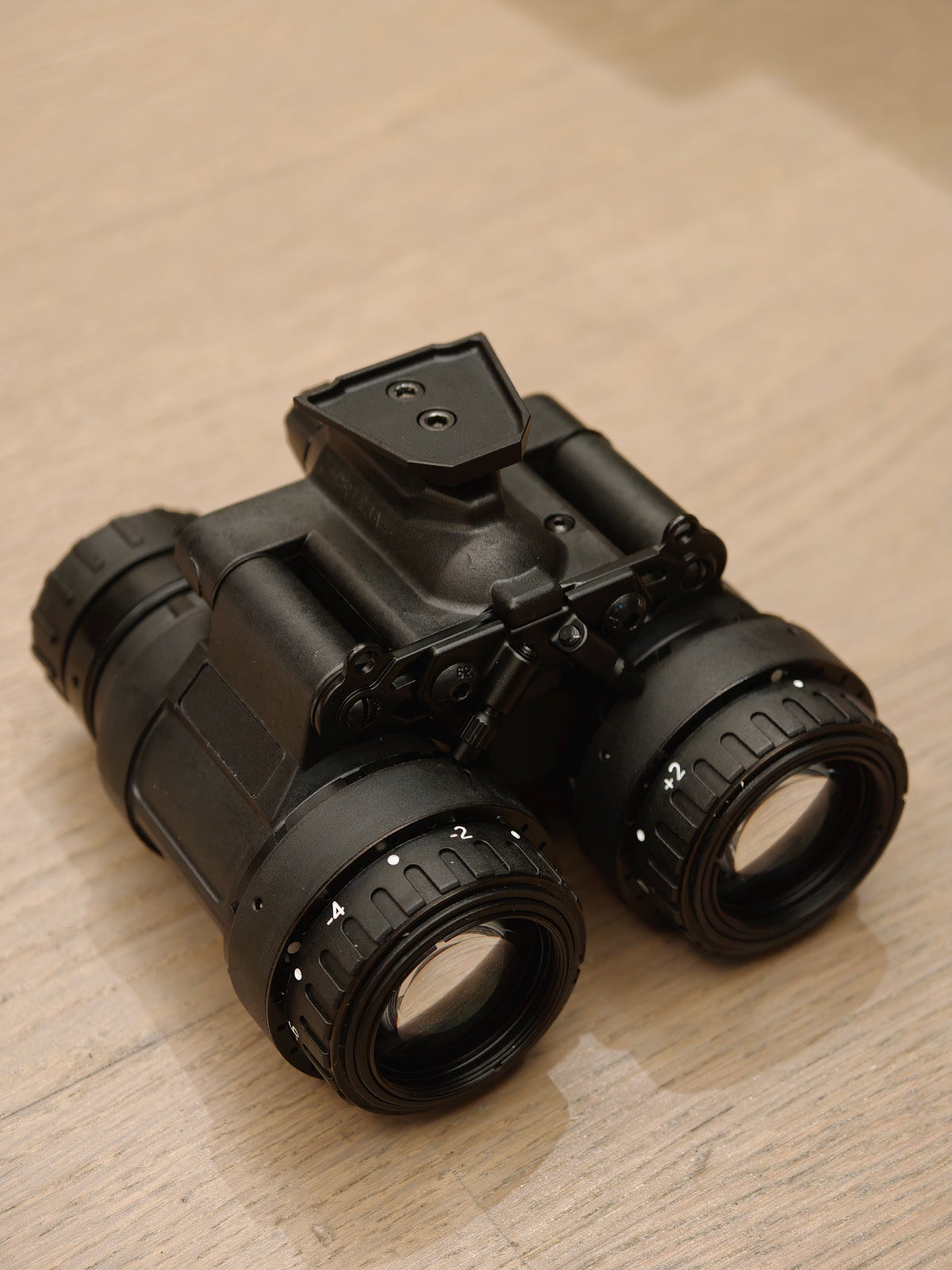 TC-X1 night vision binocular from left oblique angle, showing top mount and eyepieces